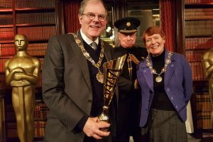 The Mayor of Sutton Cllr Richard Clifton receives the fourth place trophy from the Deputy Lieutenant of Greater London Roger Bramble DL, watched by the Mayoress Gloria Clifton.